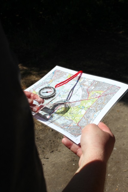 A closeup of a map and compass